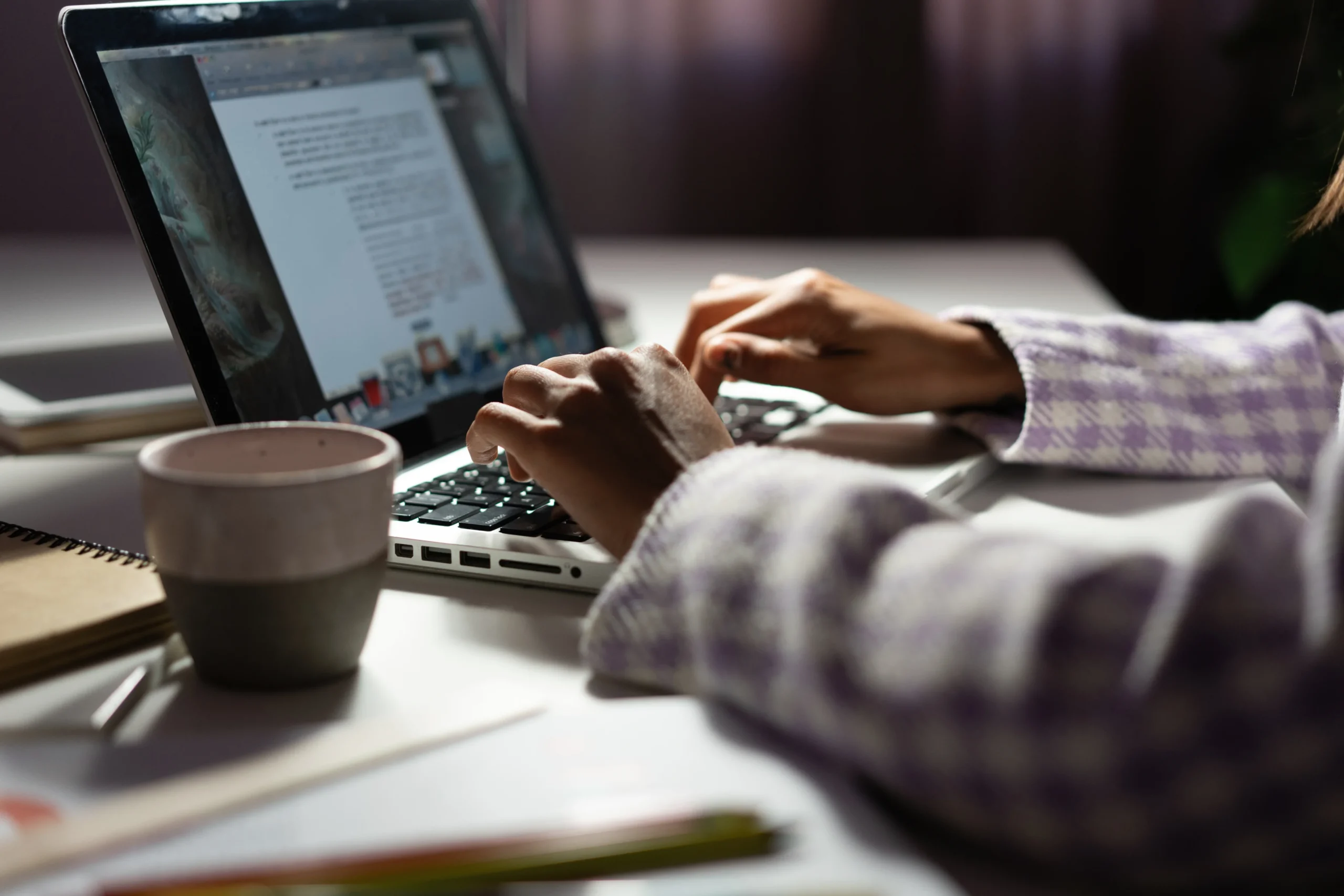 woman uses laptop while working new project idea late evening female hands are typing laptop keyboard 1